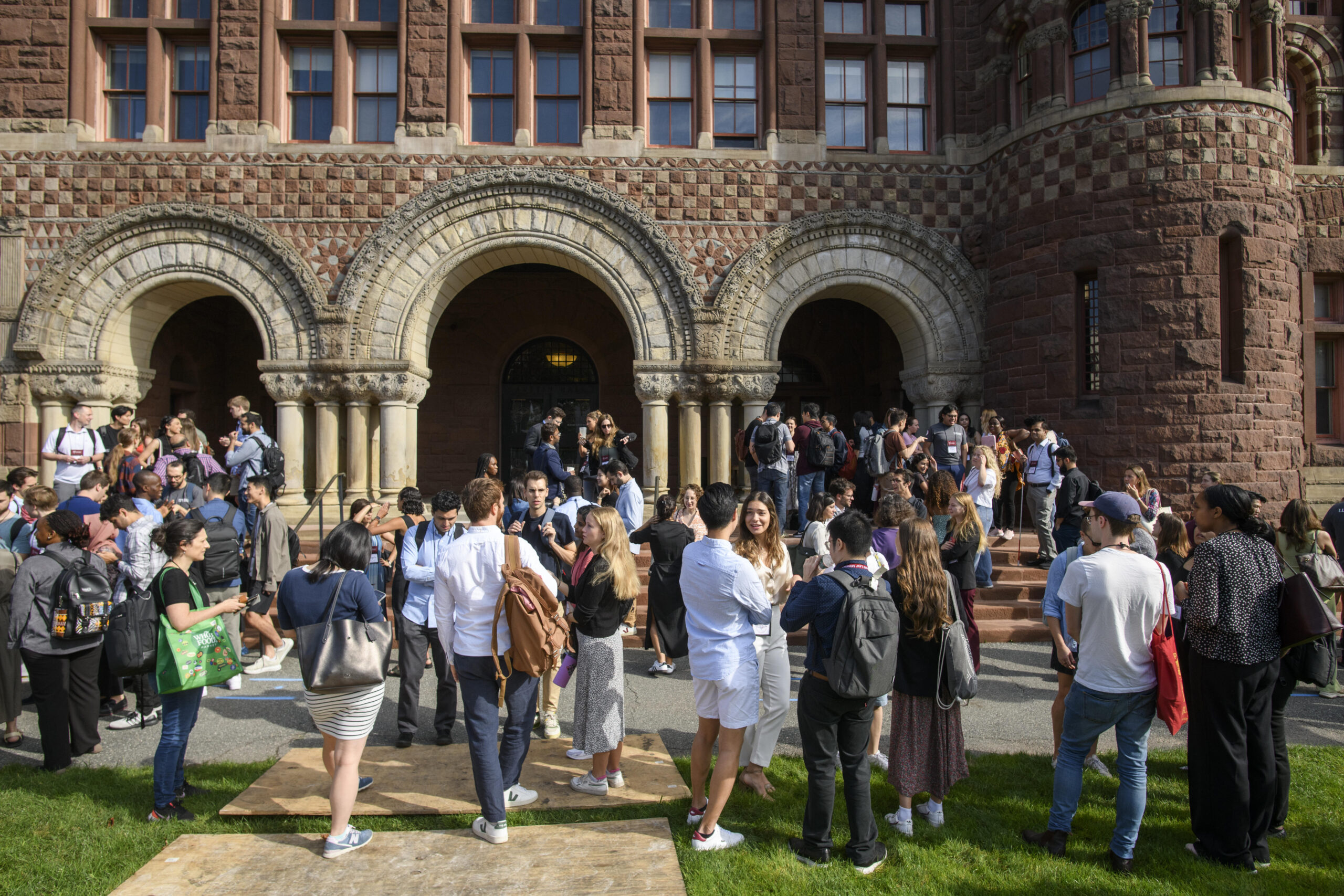 Students gathered outside a red brick building.